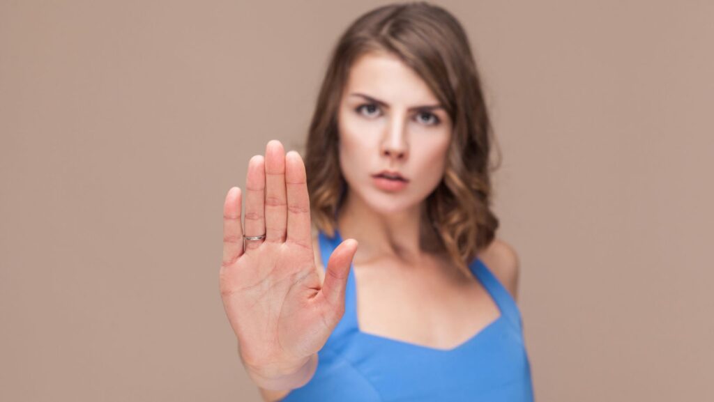 Emotional Intelligence-woman signaling to stop with her hand